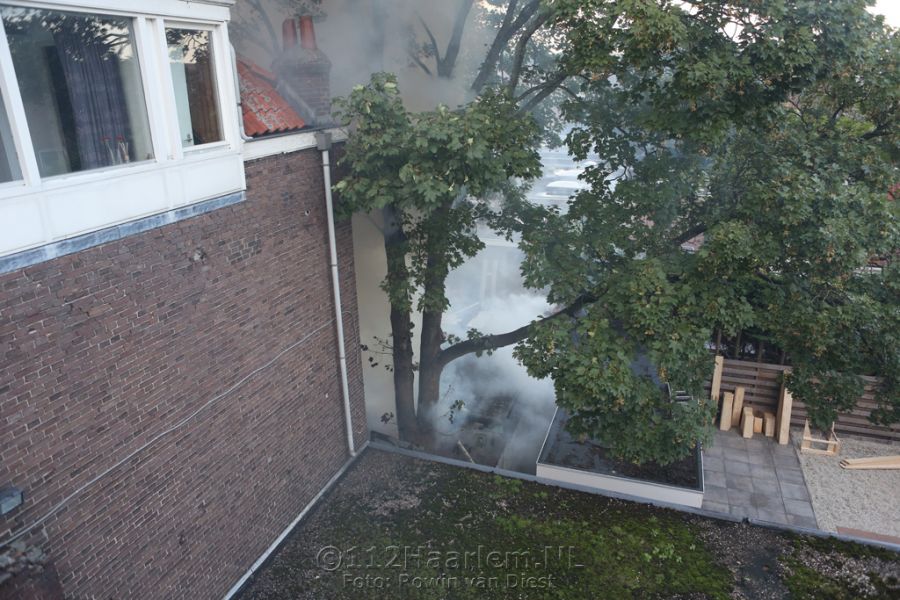 Hoge vlammen bij brand achter telefoonwinkel aan de Lange Herenstraat